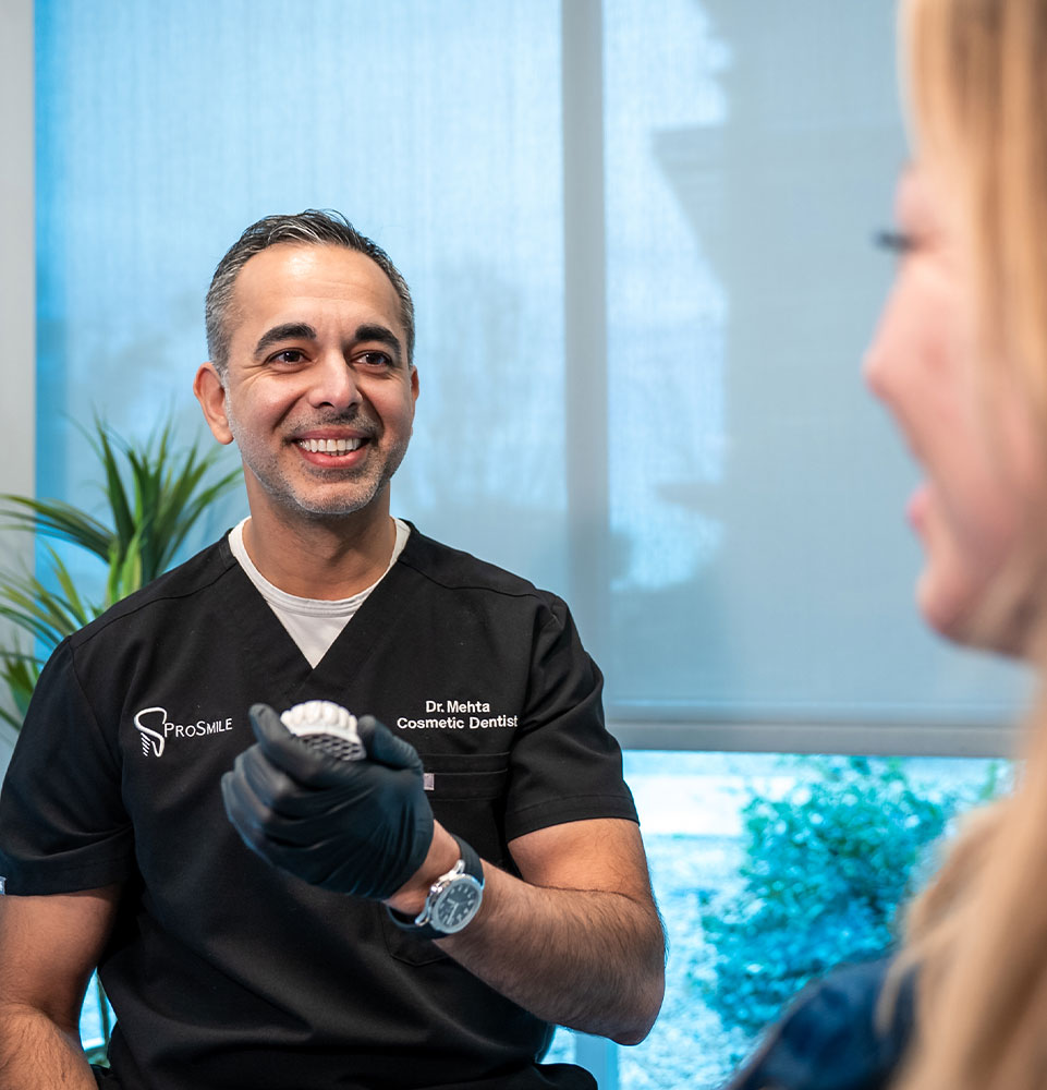 Doctor holding model of implants