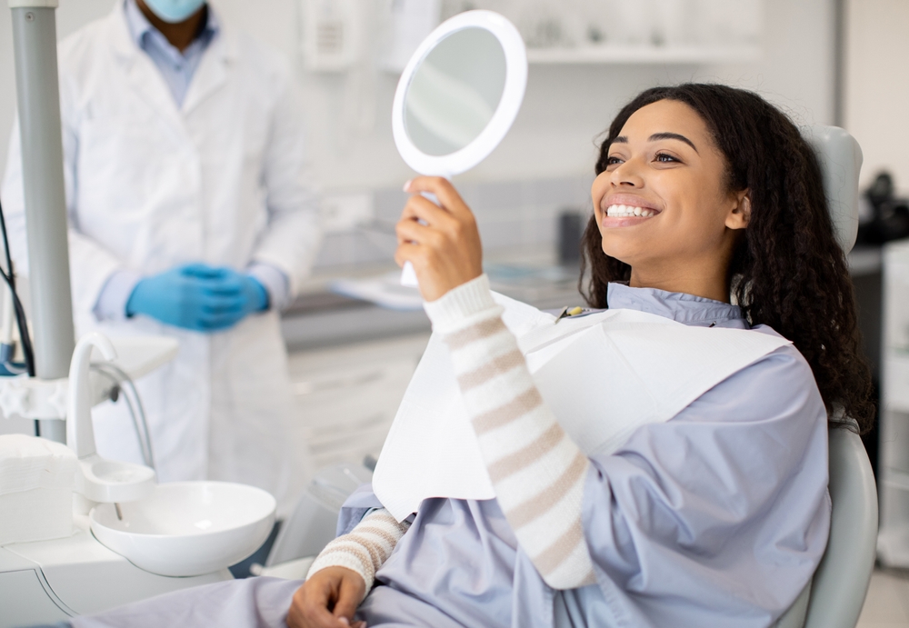Dentist in a consultation with a patient discussing crowns and veneers